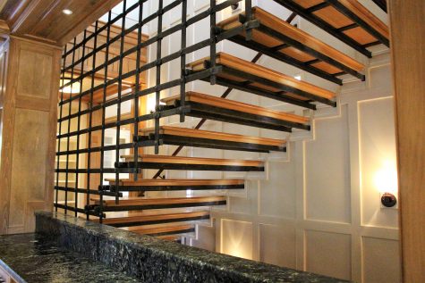 A "floating" steel and wood staircase leads to the third floor.