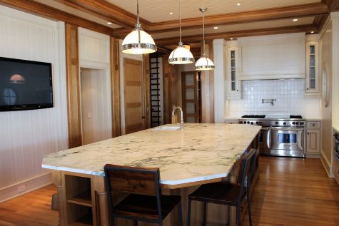 The kitchen of this home includes a large island with a hand-picked slab of marble.