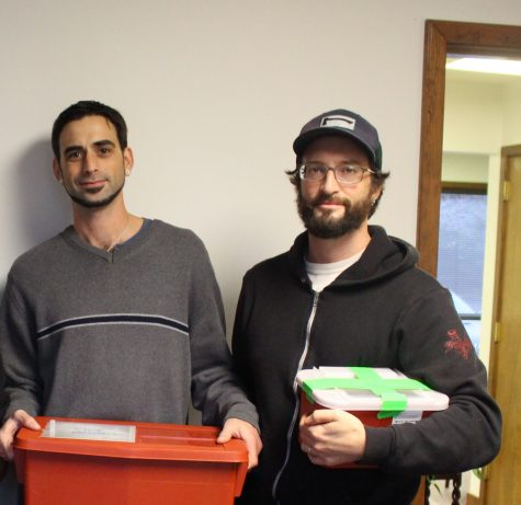 Mike Page, outreach worker, and Robert Childs, director, with recovered syringe at North Carolina Harm Reduction Coalition's Wilmington office. (Photo Benjamin Schachtman)