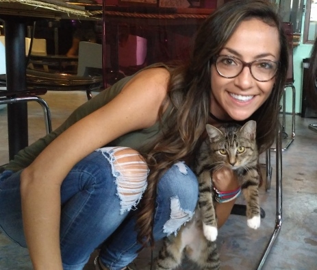 Delia Valenti with a feline companion at the Blue Cat Cafe. (Photo Courtesy Delia Eveland)