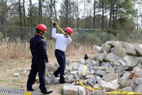 A firefighter works to break up concrete, as part of his search and rescue training.
