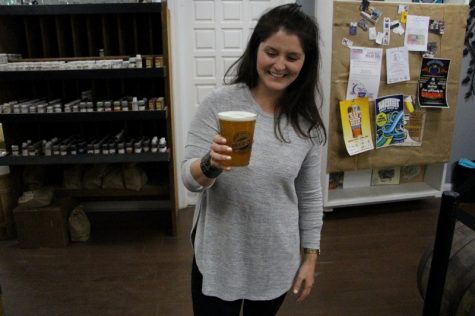 Wilmington Brewing Company's Michelle Savard offers up a 'Midtown Swank.' A new website will help beer aficionados find craft beers like this, while helpers brewers gauge interest and offset costs of new and experimental beers.