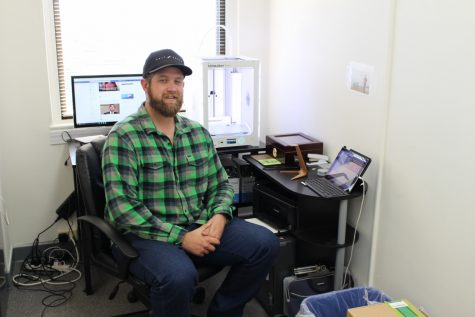 Matt Dula with his 3-D printer at his office in downtown Wilmington. (Photo Benjamin Schachtman)