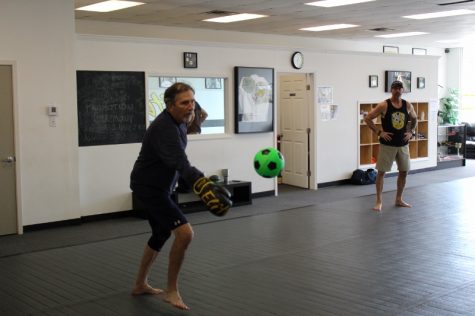 Collins working on speed drills, jabbing and uppercutting a soccer-ball. (Photo Benjamin Schachtman)