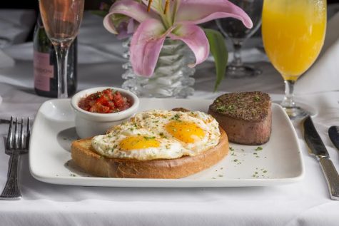 STEAK & EGGS 6 oz petite filet, poached eggs served in a garlic bread slice, roasted pepper tomato salsa, and breakfast potatoes. Photo courtesy- Ruth's Chris Steak House. 