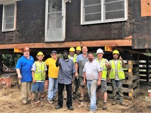 The "Highway 210 Crew," is all smiles after successfully lifting the Corbett house. (Port City Daily photo/Courtesy Bobby Fischer)