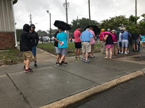 Tornado warnings and heavy rain delayed Friday's tee-times at the Wells Fargo Championship. Fans braved the elements to wait for shuttles. (Port City Daily photo / BENJAMIN SCHACHTMAN)