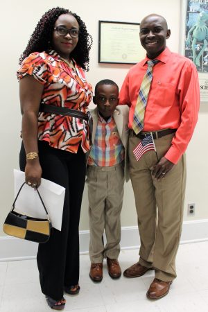 Franklin Etarock (R), with his son Francis Etarock (C) and wife Regina Ayamba. Franklin had this to say after gaining his citizenship, "Although I may have come from Cameroon, today, I am a proud citizen of the United States of America." (Port City Daily photo/CORY MANNION)