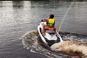 Two of Riverwalk Watersports first potential customers take one of the jet skis for a spin Friday Afternoon.