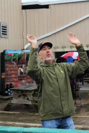 Dave Jacobs shows off bio retention pond. In the Background you can see the gutter system connected to one of the cisterns. (Port City Daily photo/CORY MANNION)