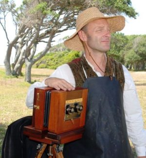 Photographer Harry Taylor and one of his 19th-century cameras. (Port City Daily photo/COURTESY OF N.C. DEPARTMENT OF NATURAL AND CULTURAL RESOURCES) 