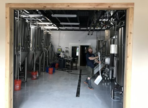 Head Brewer Zac Brown in his 'zone' - the brewing room at Waterman's - getting ready for opening day. Brown custom built the facility, and its the centerpiece of the brew-pub. (Port City Daily photo / BENJAMIN SCHACHTMAN)