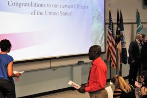 Franklin Etarock walks across the stage to recieve his official citizenship papers. (Port City Daily photo/CORY MANNION)