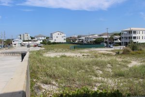 The vacant lot across from Johnny Mercers Pier in Wrightsville Beach could see the construction of duplexes if approved. (Port City Daily photo/MICHAEL PRAATS)