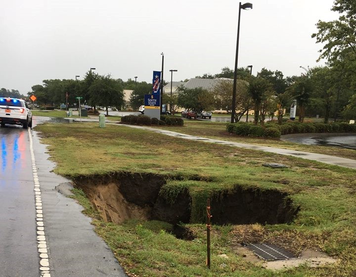 A sinkhole, similar to the one pictured above in Sunset Beach, has formed near the entrance of Belmar Forest, a subdivision off Gordon Road. (Port City Daily/File photo)