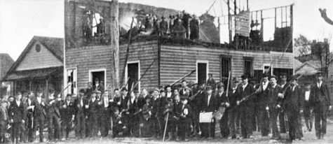 Library of Congress photo of white-supremacist rioters on November 26, in front of the destroyed Daily Record building. (Port City Daily / LIBRARY OF OF CONGRESS)