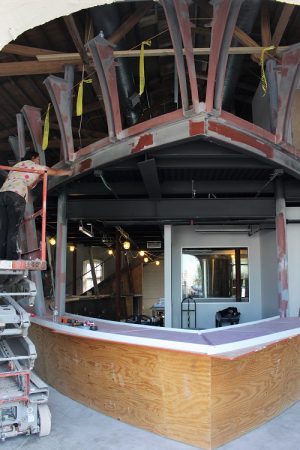 The bar itself is built to look like the prow of a pirate ship, just like the 'Queen Anne's Revenge,' with curved lines, large windows and hanging lights giving patrons the impression of being at sea. (Port City Daily photo / CORY MANNION)