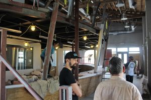 Head Brewer Erik Peterson (L) and consultant Jim Holden (R) observe the construction on their new taproom. (Port City Daily photo/CORY MANNION)