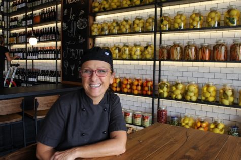 Chef Roberta Campani. In the background, preserved lemons and oranges, pickles, and - of course - a lot of Italian wine. (Port City Daily photo / BENJAMIN SCHACHTMAN)