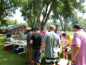 Hamburger and hotdog feast with all the trimmings shared by Lions, family members, and residents of Lions Cottage.