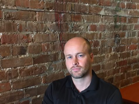Midmost Coast host J. Allen Henderson attempting his best 'serious podcast host' pose. (Port City Daily photo / BENJAMIN SCHACHTMAN)