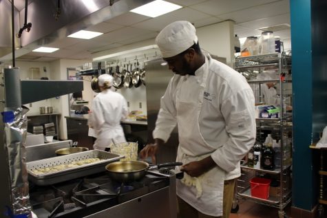Chris Smith poaches trout quenelles to pair with a classic French bisque; Smith is one of five CFCC students who cooked the meal. (Port City Daily photo / BENJAMIN SCHACHTMAN)