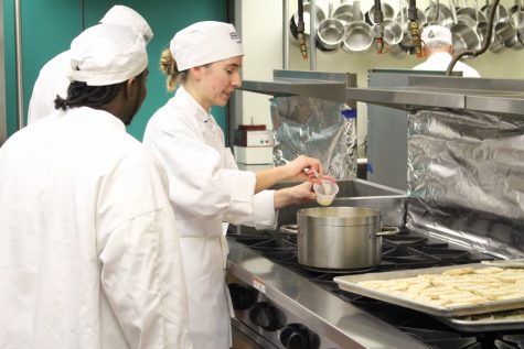 Student Madison Smith checks the salt on a classic French bisque. (Port City Daily photo / BENJAMIN SCHACHTMAN)