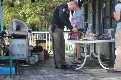 Captain Brian Chism searching through belongings of one of the 30 arrested suspects Thursday in a large-scale, Brunswick County drug sweep (Port City Daily photo / MICHAEL PRAATS)