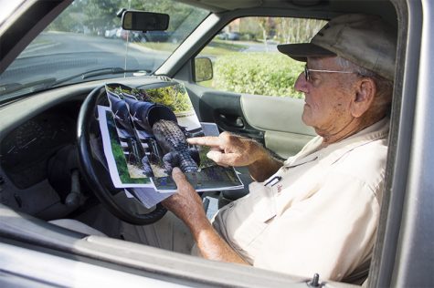 Jimmy English, the go-to man in North Carolina for alligator removal in residential areas, looks over some of his notable cases. (Port City Daily photo/ JOHANNA FEREBEE)