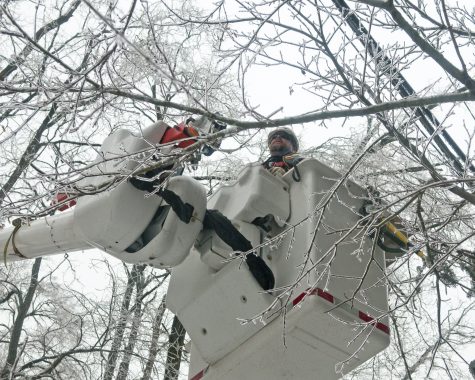 A Duke Energy employee in a bucket working on ice covered power lines after an ice storm. (Port City Daily photo/COURTESY DUKE ENERGY)