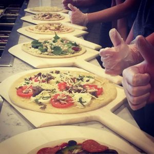 Your PIe pizzas on the line, ready for the oven. (Port City Daily photo / COURTESY YOUR PIE PIZZA)