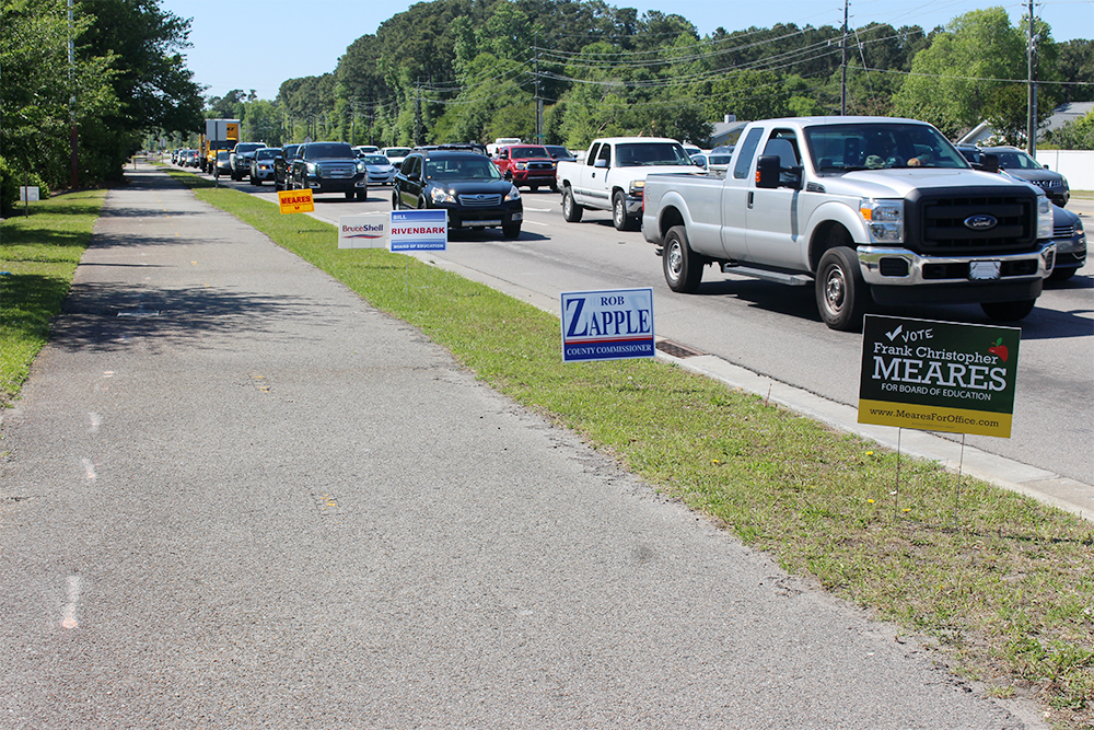 Political signs lined up on Eastwood Road in Wilmington. Eastwood Road is maintained by the NCDOT, therefore is an eligible right-of-way for politicians to erect campaign signage during election season. (Port City Daily/Johanna Ferebee)