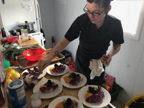 Chef Chelsea Moran puts the finishing touches on the appetizer course; despite the cramped beach-rental kitchen, she had no problem preparing the meal. (Port City Daily photo | Benjamin Schachtman)
