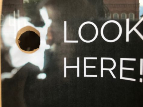 You can get a sneak peak at the construction progress through a peep hole in the front window of Crust Kitchen and Cocktails. (Port City Daily photo | Benjamin Schachtman)