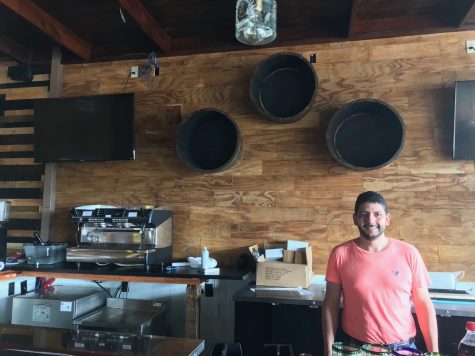 Ramon Villasenor-Castro behind the nearly-refurbished bar at Tequila Comida and Cantina. The wall is decorated with ex-tequila barrels and will be lined with a variety of tequilas, mezcals and whiskies when completed. (Port City Daily photo | Benjamin Schachtman)