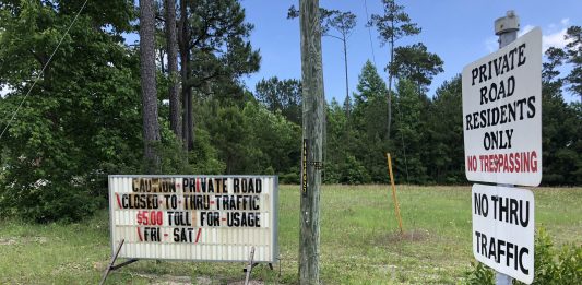 Members of the neighborhood road maintenance organization elected to collect a toll for through traffic traveling to Surf City (Port City Daily photo/Michael Praats)