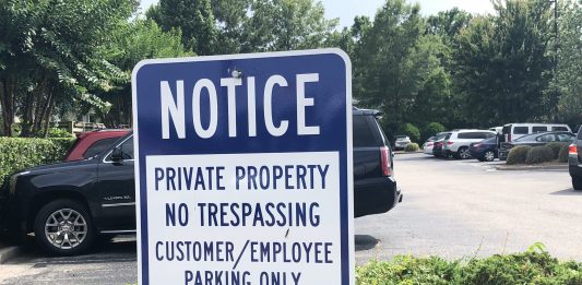 Towing companies typically have contracts with private property owners to remove unauthorized vehicles, but what happens when they remove vehicles legally on the property? (Port City Daily photo/Michael Praats)