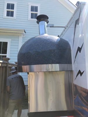 The wood-burning oven hanging off the back of the food truck was a unique concept that Kevin said he has never seen done. (Port City Daily/Michael Praats)