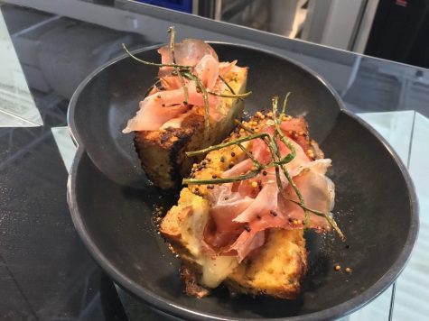 Chef Micah Edelstein's take on a Monte Cristo, with speck and Havarti on french toast made from a twice baked bread pudding, which Edelstein makes with biscuits in place of bread. The sandwich is topped with fried chives and an IPA beer mustard. (Port City Daily photo | Benjamin Schachtman)