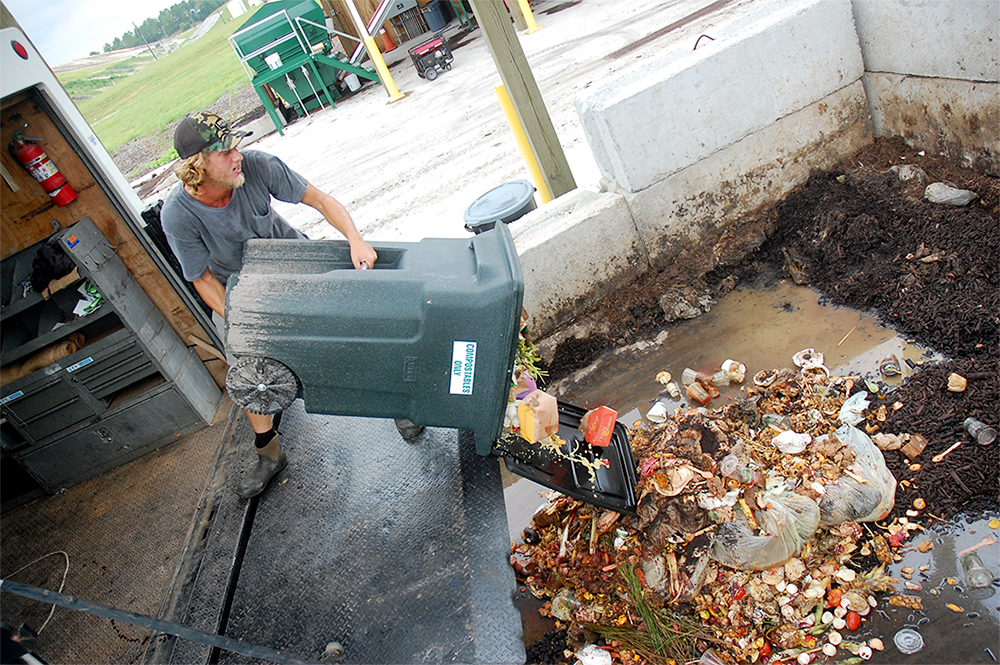 Riley Alber, owner of Wilmington Compost Company, drops off food waste at New Hanover County's composting facility Wednesday. (Port City Daily photo/Johanna Ferebee)