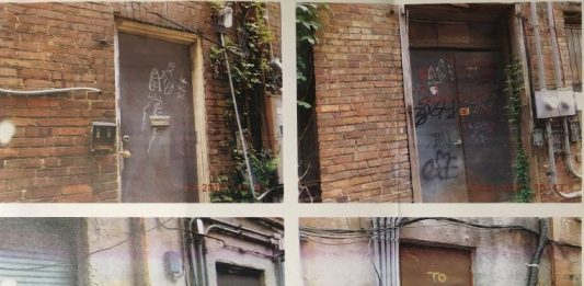 The graffiti on the south wall of Cabic Alley, which does not belong to Thomas Harris. This photograph was included in the citation sent to the Front Street Brewery owner. (Port City Daily photo | City of Wilmington)