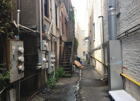 Cabic Alley, from Front Street. The staircase and electric meters pictured in the city's citation notice are clearly visible on the left; Front Street Brewery is on the right. (Port City Daily photo | Benjamin Schachtman)