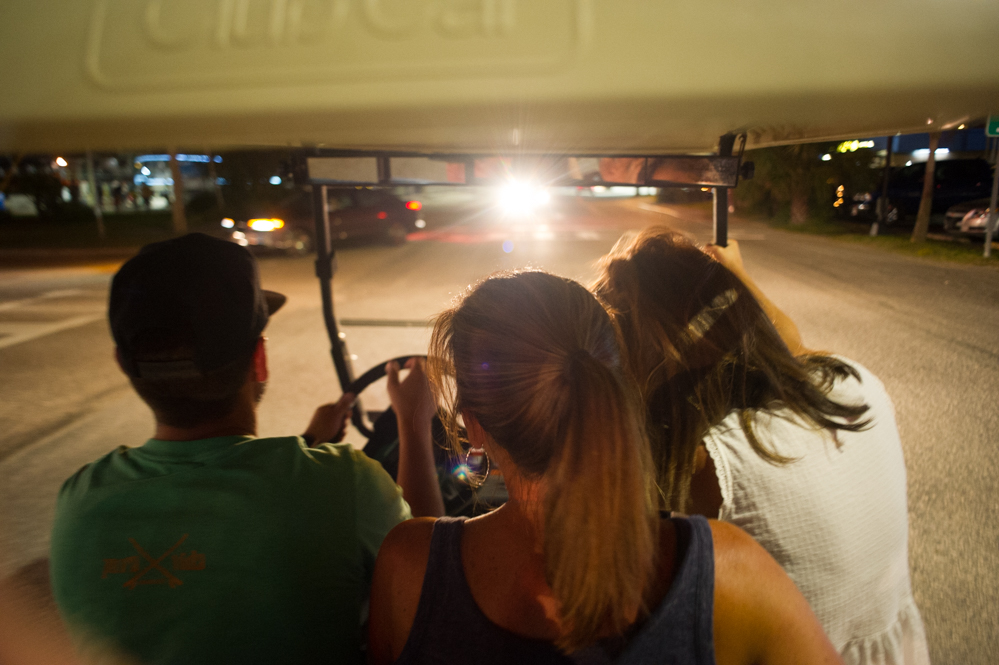 Carolina Beach residents drive a golf cart down Lake Park Boulevard. (Port City Daily photo | Mark Darrough)
