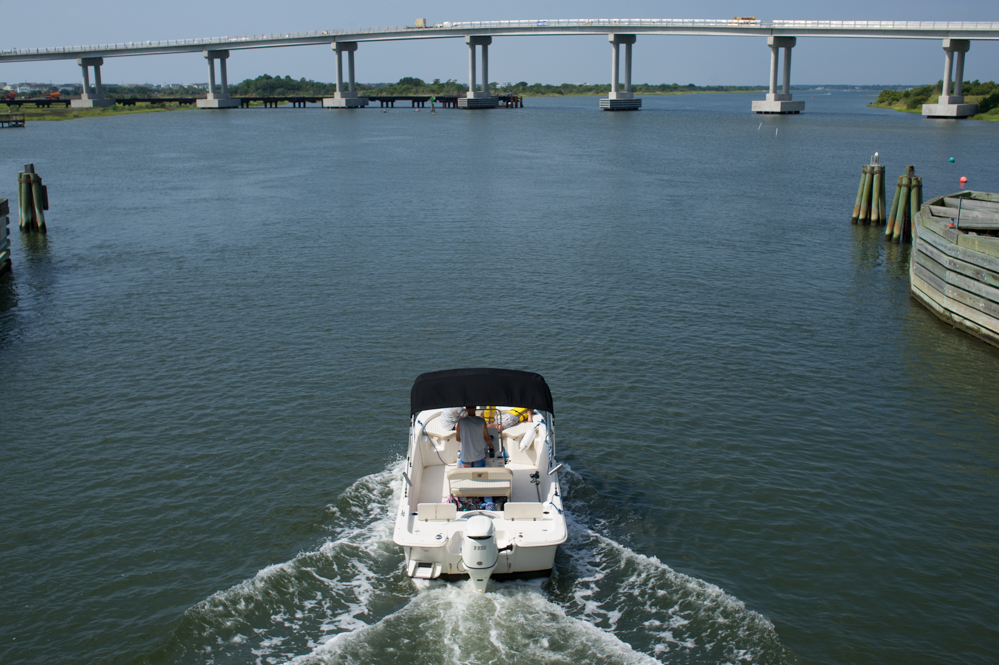 After passing beneath the swing bridge, a boat heads towards the new Topsail Island bridge on the Intracoastal Waterway in Surf City, August 23, 2018. (Port City Daily photo | Mark Darrough)