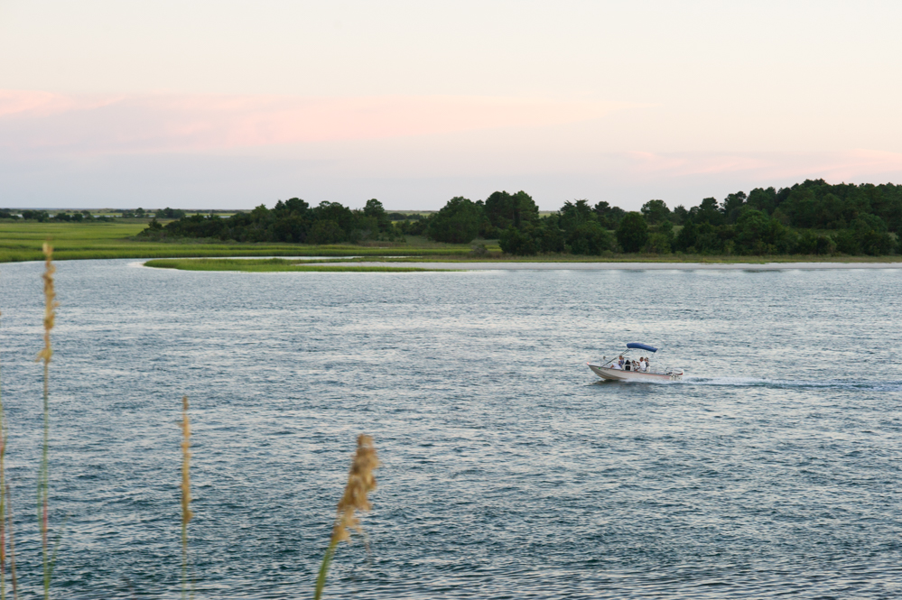 A boat heads down Shinn Creek toward Masonboro Inlet, 7:43 p.m., August 28, 2018. (Port City Daily photo | Mark Darrough)