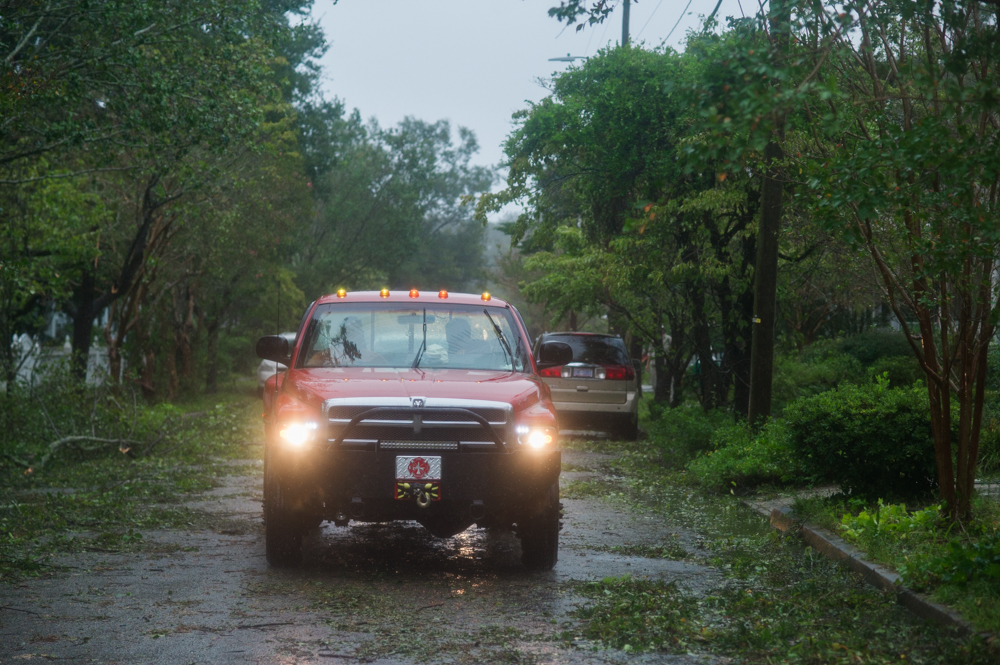 A City of Wilmington Fire and Rescue truck drives through the Carolina Place neighborhood east of downtown Wilmington during the calm between the inner bands of Hurricane Florence Friday morning. (Port City Daily photo | Mark Darrough)