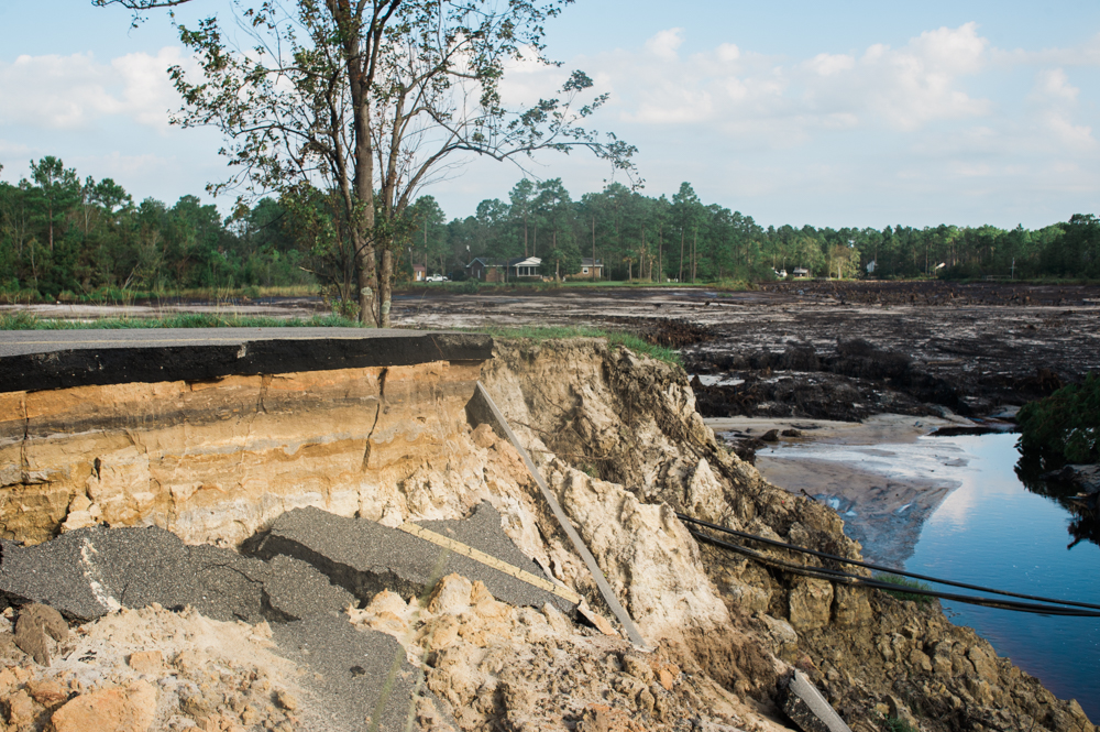 One of the large washouts on Boiling Spring Lakes Road, the now empty Patricia Lake in the background, Sunday morning, September 22, 2018. (Port City Daily photo | Mark Darrough)