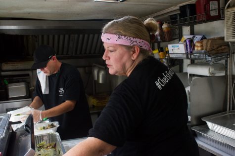 Michelle "Momma" Rock, owner of T'Geaux Boys food truck, and Harvey Bruce, owner of Poor Piggy's BBQ, hand out chef-prepared World Central Kitchen meals at Gateway Community Baptist church in Burgaw on Wednesday, Saturday 26, 2018. (Port City Daily photo | Mark Darrough)