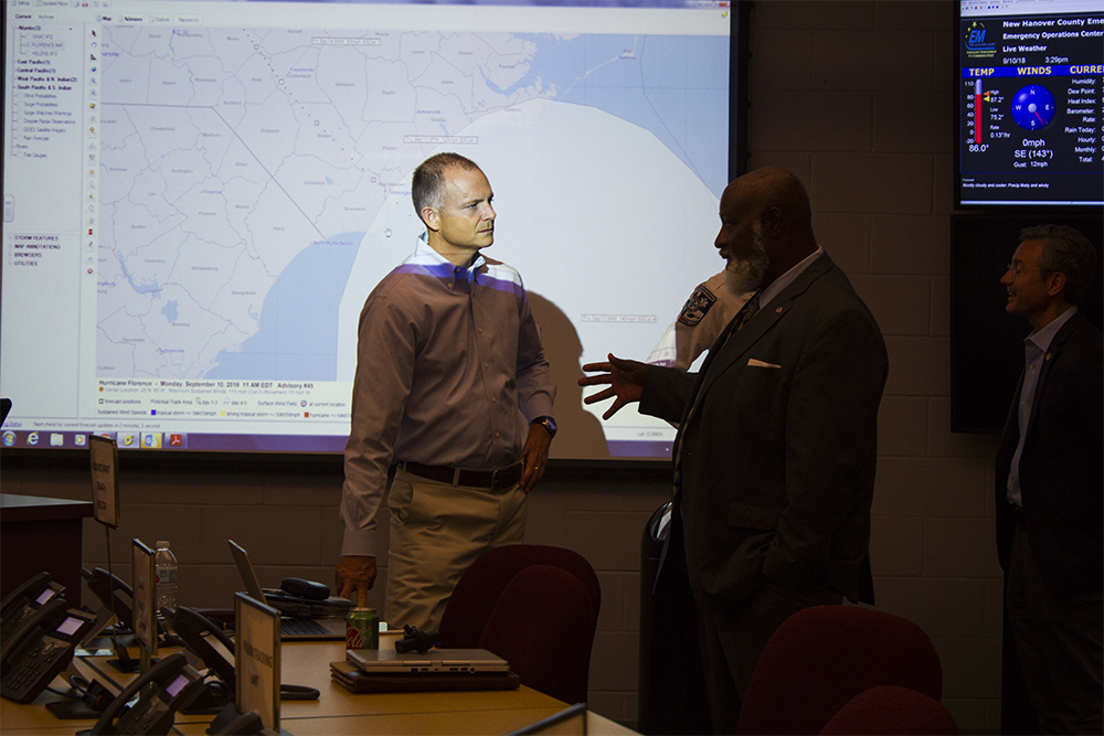 New Hanover County Commissioner Woody White speaks with Commissioner Jonathan Barfield at the county's Emergency Operations Center Monday. (Port City Daily photo/Johanna Ferebee)