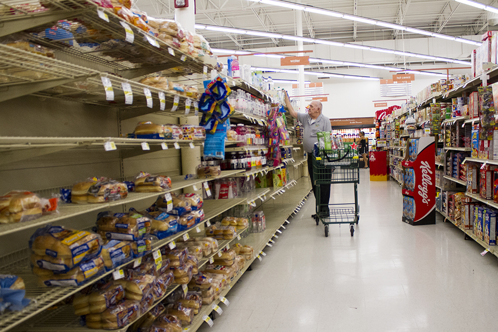 A man shops at the Lowe's Foods in Wilmington Monday. Goods like water, bread and milk were picked through at area grocery stores as residents prepared for Hurricane Florence's arrival. (Port City Daily photo/Johanna Ferebee)